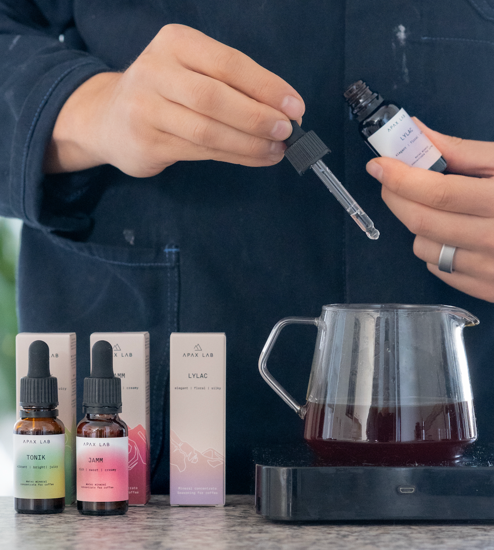 Barista adding drops of LYLAC mineral concentrate into its filter coffee (post-brewing mineralisation).